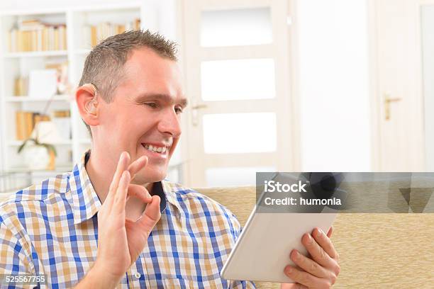 Deaf Man Using Sign Language On The Tablet Stock Photo - Download Image Now - Sign Language, Deafness, Adult