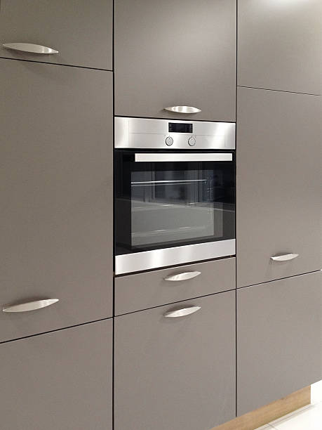 istock Modern metallic stainless steel oven in the kitchen with kitchen cabinets 525568759