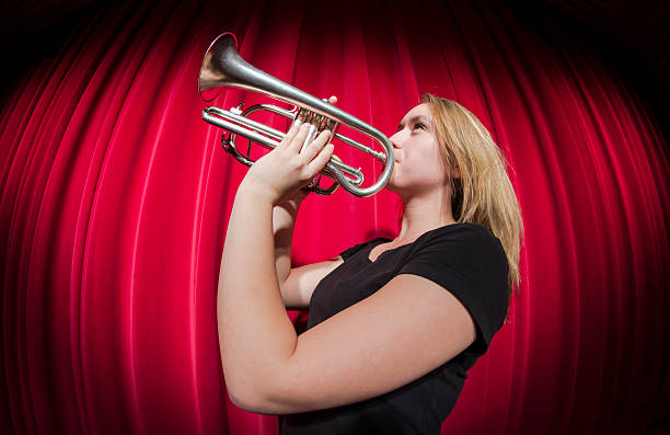 istock Girl playing trumpet 525571155