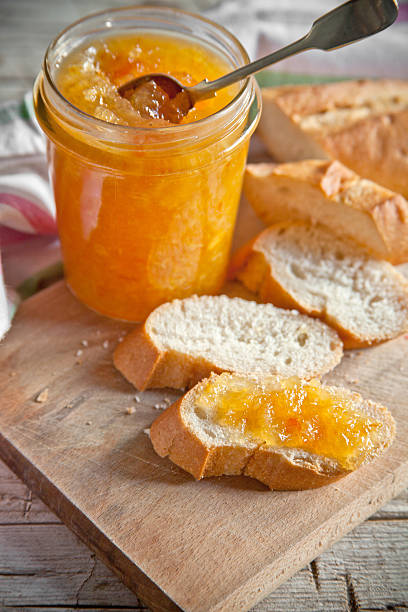 istock orange jam in a glass jar and bread 525574389