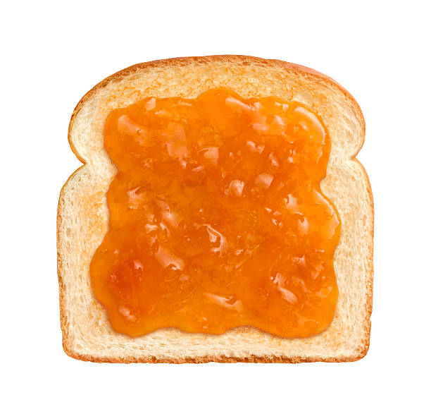 Apricot Preserves on Toast  Straight on vew of Apricot Preserves on a single slice of lightly toasted white bread.  This is ideal to serve at breakfast time.  Apricots are a juicy, soft fruit, resembling a small peach.  They are usually an orange-yellow color.  The image is isolated on a white background. marmalade stock pictures, royalty-free photos & images