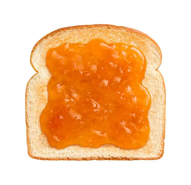  Straight on vew of Apricot Preserves on a single slice of lightly toasted white bread.  This is ideal to serve at breakfast time.  Apricots are a juicy, soft fruit, resembling a small peach.  They are usually an orange-yellow color.  The image is isolated on a white background.