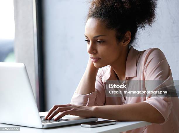 Young Black Woman Looking At Laptop Stock Photo - Download Image Now - Women, One Woman Only, Serious