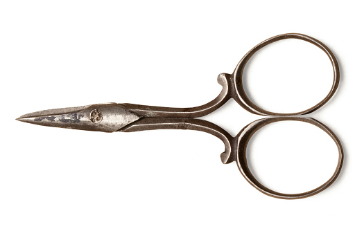 Ancient small scissors isolated on a white background