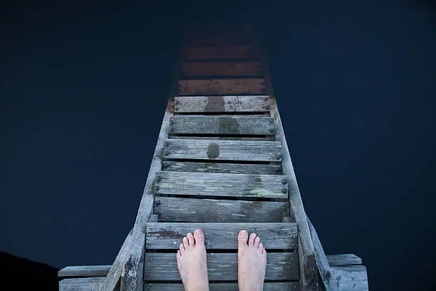 Photo of Man standing and thinking on a pier