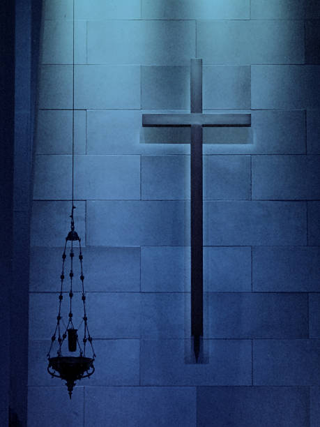 istock Solemn Catholic Blue Lighted Cross and Hanging Candle 525584723