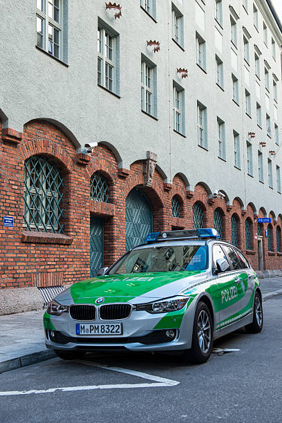 German Police Car Munich, Germany - October 26, 2014: BMW Police car parked in front of the police station, at Munich downtown sentinel spire stock pictures, royalty-free photos & images