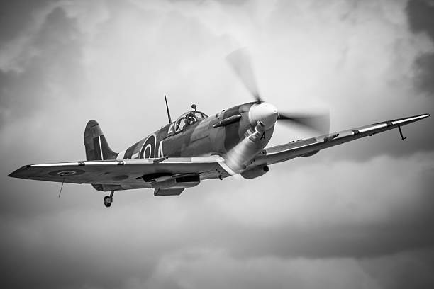 Duxford, UK - May 25, 2014: A Spitfire LF.Vb fighter  aircraft of Second World War vintage in flight over an airfield in Cambridgeshire, England. 