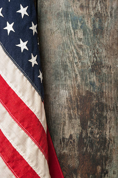 American flag on old barn board background stock photo