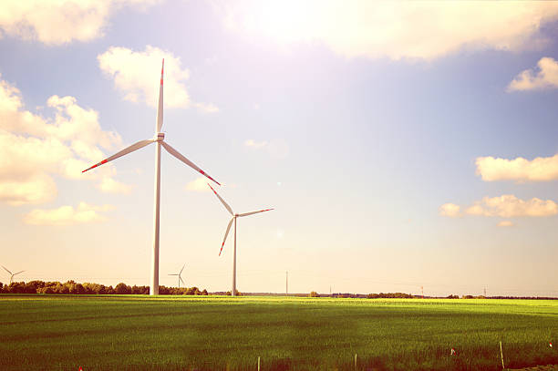 Windmills. Alternative energy Windmills on the green field against sunshine sky at summer. Alternative energy environmental pressure oven photos stock pictures, royalty-free photos & images
