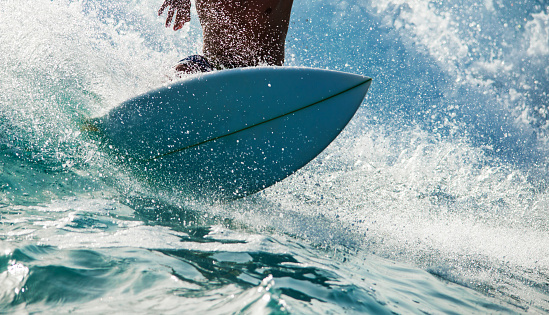 Unrecognizable person riding a wave.