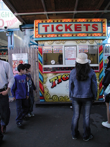 New York City, NY, USA - April 27, 2003: Kids gather by the ticket booth to buy tickets for the rides. 