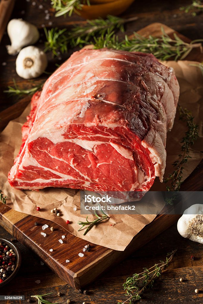 Raw Grass Fed Prime Rib Meat Raw Grass Fed Prime Rib Meat with Herbs and Spices Animal Blood Stock Photo