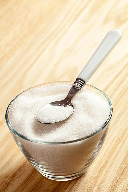 istock Spoon in a bowl of sugar 525625123