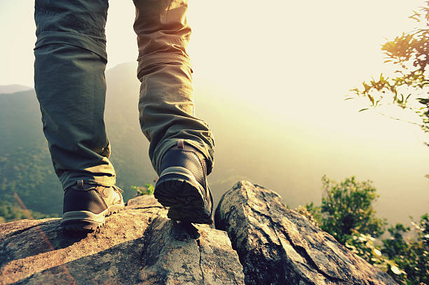 istock hiking feet  mountain peak rock 525626073
