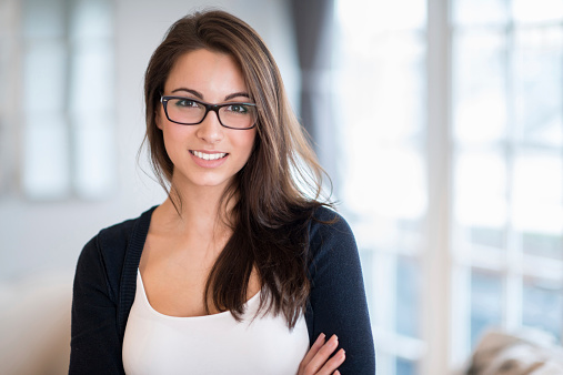 Beautiful woman at home wearing glasses