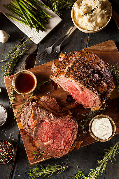 Homemade Grass Fed Prime Rib Roast Homemade Grass Fed Prime Rib Roast with Herbs and Spices roasted stock pictures, royalty-free photos & images