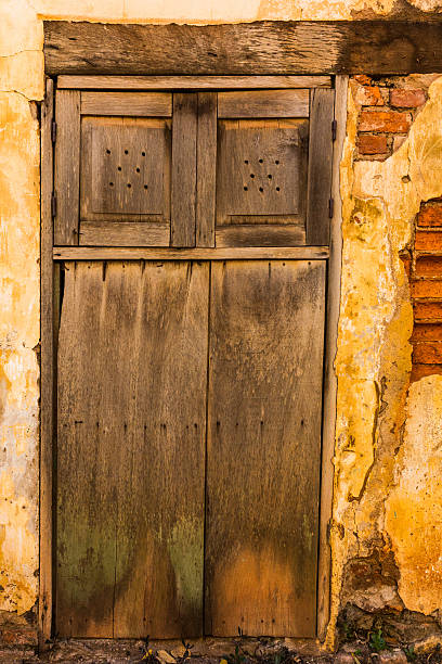 old brick wall with wooden door stock photo
