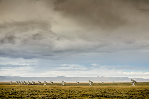 The Very Large Array radio telescope in New Mexico under heavy clouds