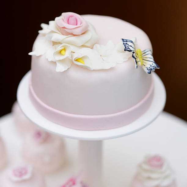 istock Delicious pink wedding cake and cupcakes 525627567