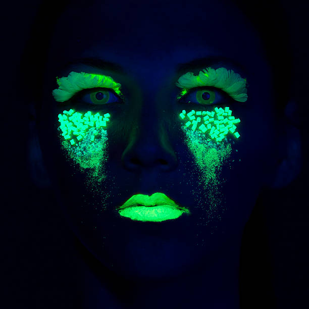 istock Woman Portrait painted with UV makeup color 525628253