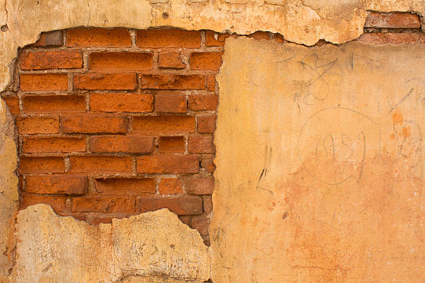 old brick wall with cracked stucco stock photo