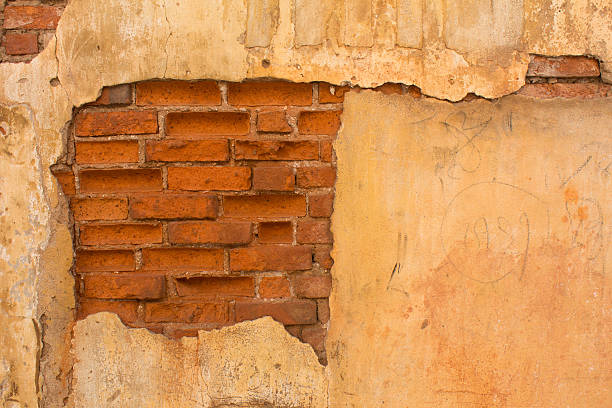 old brick wall with cracked stucco stock photo