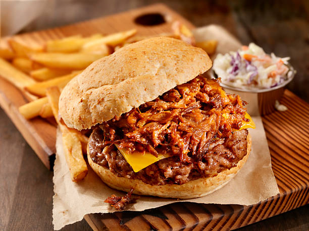 pulled pork hamburger - cheese focus on foreground on top of portion stock-fotos und bilder
