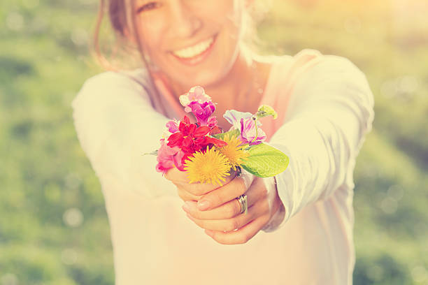 istock Smiling girl holding flowers. 525630997