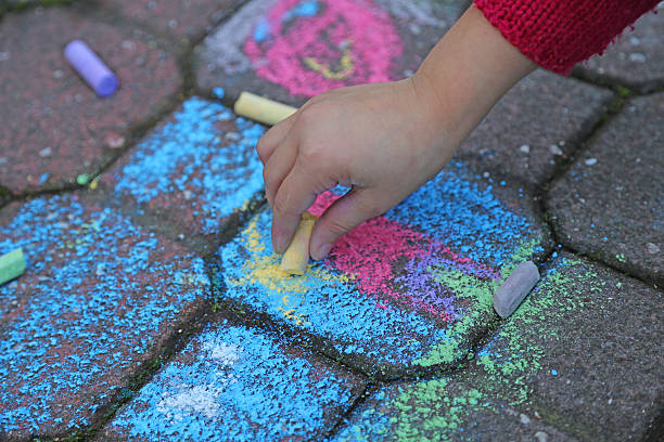 istock young girl draws with the colourful chalks 525635777