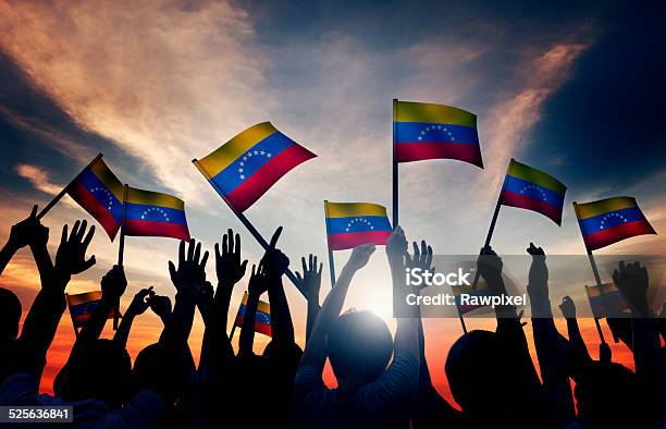 Grupo De Personas Agitando Venezolano Flags En Contraluz Foto de stock y más banco de imágenes de Venezuela