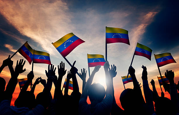 Group of People Waving Venezuelan Flags in Back Lit