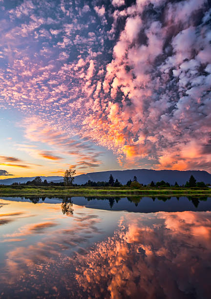 Dramatic Pink Clouds Reflection stock photo