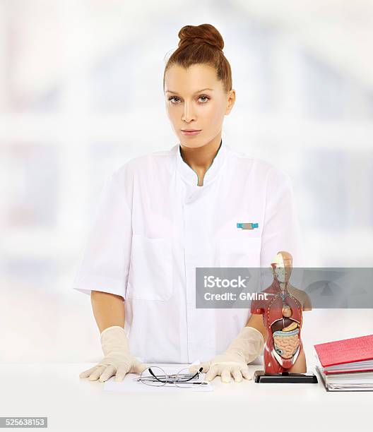 Doctor Standing By Her Desk Stock Photo - Download Image Now - Adult, Adults Only, Beauty