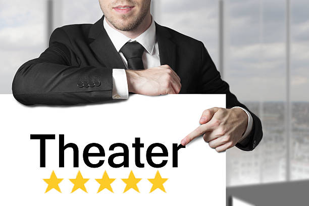istock businessman pointing on sign theater five stars 525638593