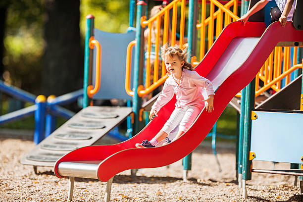 Pakistan immigrants in Denmark. Family living in Horsens, Jutland. The daughter at the playground, sliding on the slide.
