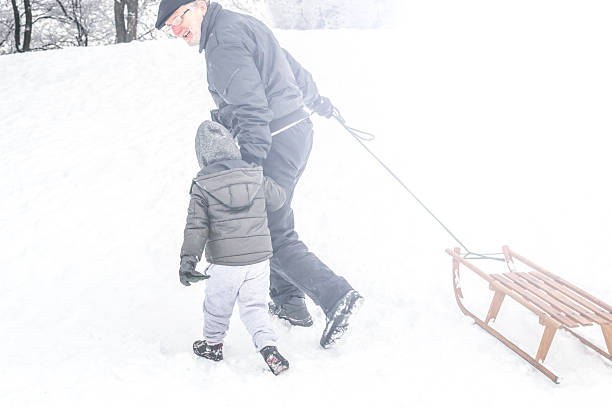 istock Grandfather and grandson on a winter day 525639977