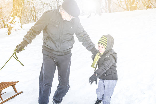 istock Grandfather and grandson on a winter day 525639983