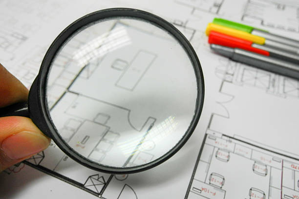 istock Magnifier glass and paper part of architectural project 525640557