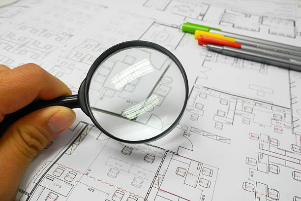 istock Magnifier glass and paper part of architectural project 525640559