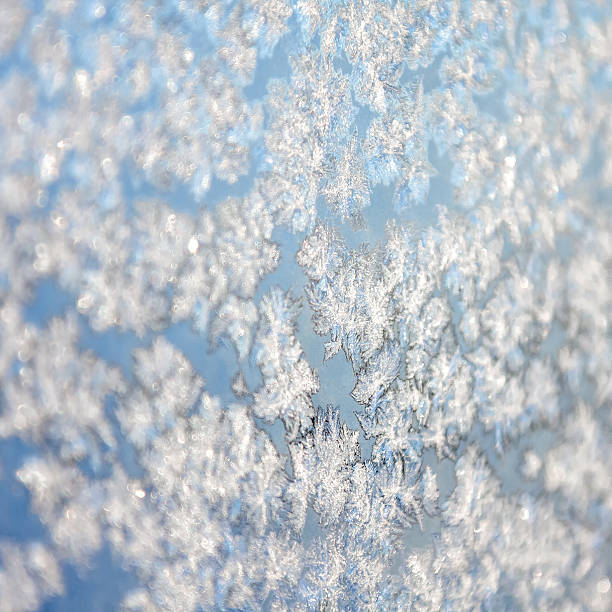 istock Snowflakes on frozen window 525641449