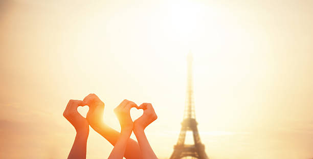 istock Two lovers showing heart shapes 525641883