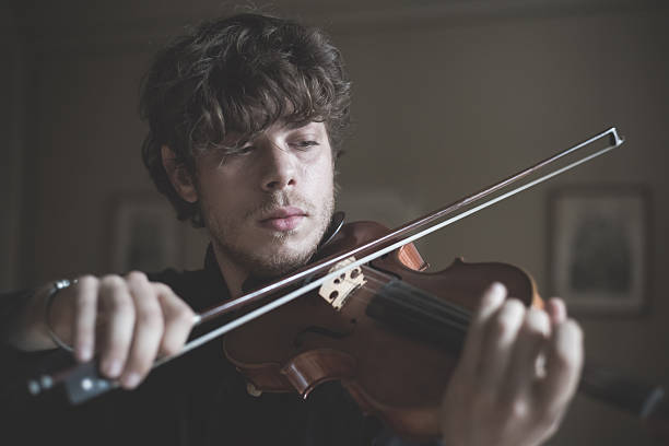 istock young handsome blonde violinist 525649407