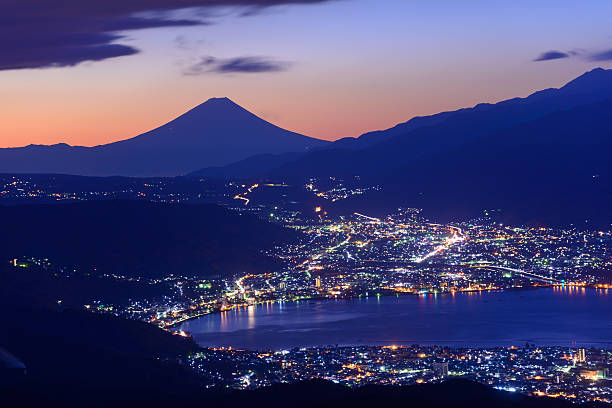 Lights of Suwa city and Mt.Fuji at dawn From near the summit of Mt. Takabocchi an altitude of 1665 meters, time of dawn, view of the east direction, Lake Suwa and Mount Fuji. suwa lake photos stock pictures, royalty-free photos & images