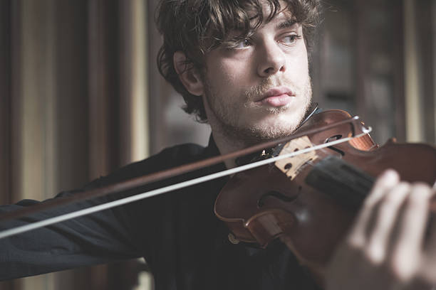 istock young handsome blonde violinist 525650257