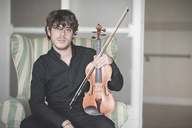 istock young handsome blonde violinist 525652835