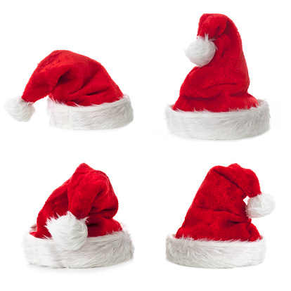 Cuatro sombrero de Santa Claus sobre fondo blanco photo