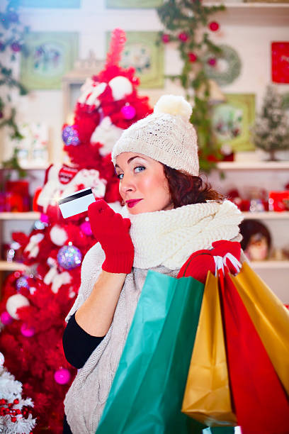 istock Cute girl makes funny face while showing your credit card 525655097