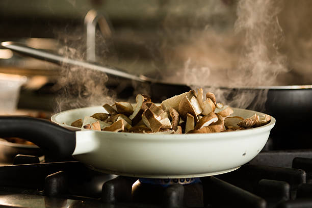 Shiitake dish on stove Preparation of Shiitake dish on stove braising pan stock pictures, royalty-free photos & images