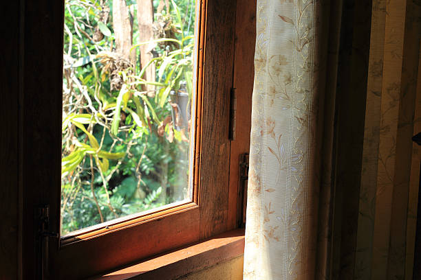 istock curtain at the window in morning 525656119